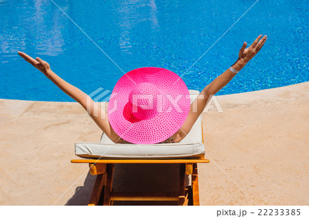 happy woman with hat sunbathing on a sun lounger 22233385