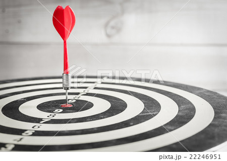 Red dart arrow hitting in the center of dartboard Red dart arrow hitting in the center of dartboard 22246951