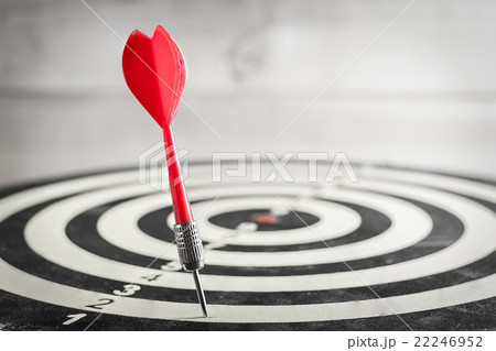 Red dart arrow missed in the center of dartboard 22246952