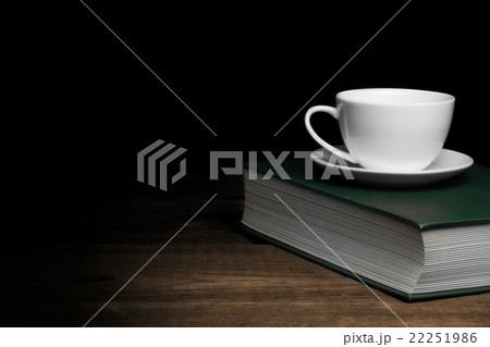 Empty Tea Cup On The Green Old Book In Dark Empty Tea Cup On The Green Old Book In Dark 22251986