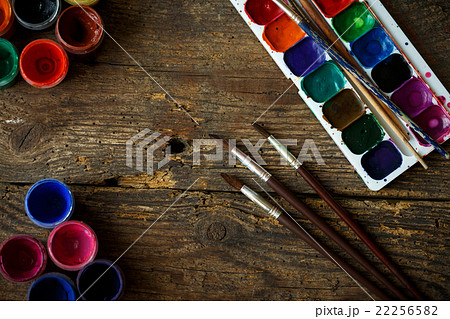 Watercolors and paint brush on wooden background 22256582