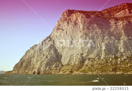Mountain rock cliff near the sea Mountain rock cliff near the sea 22259315