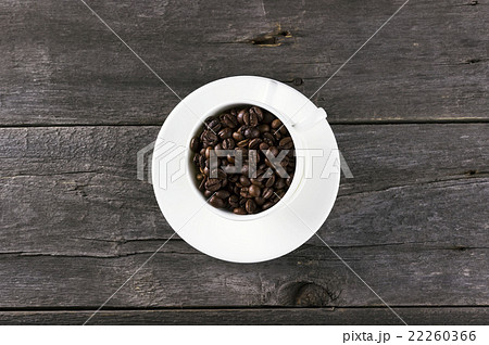 Coffee grains on dark wooden background Coffee grains on dark wooden background 22260366
