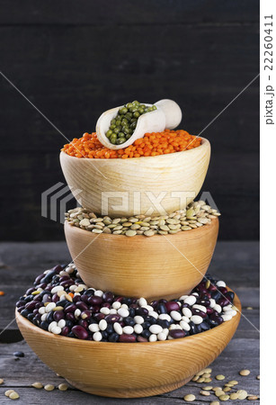 Various bean on dark wooden background Various bean on dark wooden background 22260411