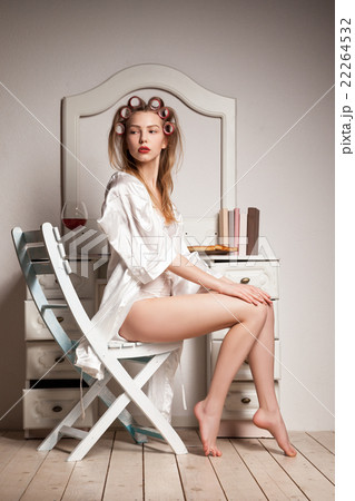 Pretty woman in a dressing-gown and curlers 22264532