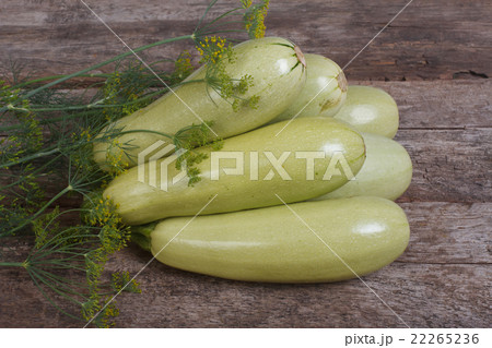Fresh zucchini with dill on a old wooden board Fresh zucchini with dill on a old wooden board 22265236
