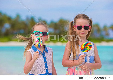 Two little girls with bright tasty lollipops on 22266417