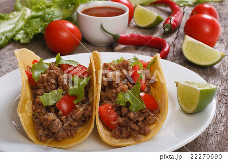 Tacos stuffed with ground beef and chili sauce 22270690