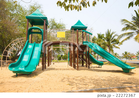 Green playground on yard in the park with tree 22272367