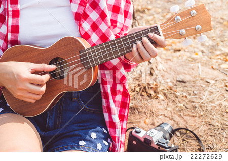 Beautiful asian women playing ukulele guitar  22272629
