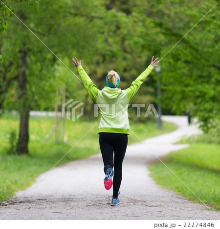 Sporty young female runner in city park. 22274846