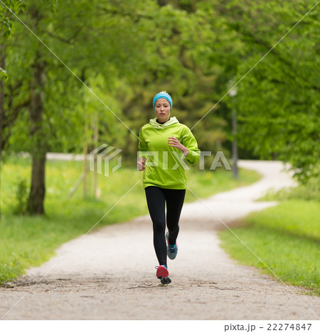 Sporty young female runner in city park..  22274847