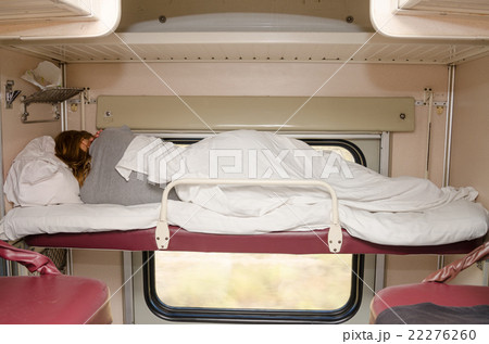 Passenger train sleeping on the top shelf of the side seats in the second-class carriage turned to Passenger train sleeping on the top shelf of the side seats in the second-class carriage turned to 22276260