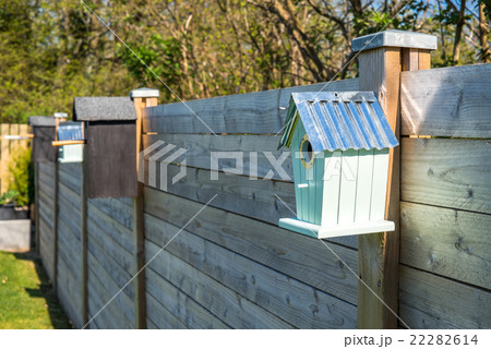 Bird houses on a row at a fence Bird houses on a row at a fence 22282614
