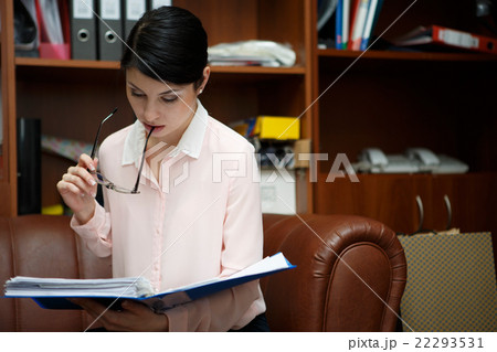 Young woman reading some documents Young woman reading some documents 22293531