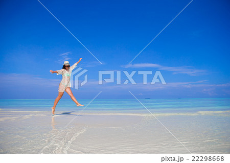 Young woman enjoy tropical beach vacation Young woman enjoy tropical beach vacation 22298668