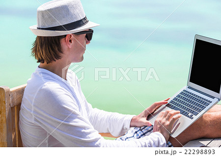 Young man with tablet computer and cell phone on 22298893
