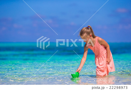 Adorable little girl playing with origami boat in Adorable little girl playing with origami boat in 22298973