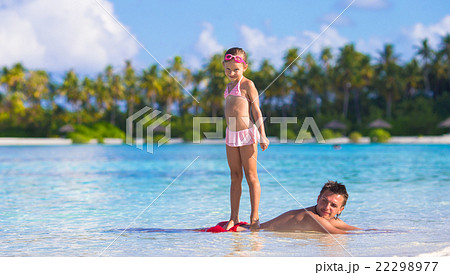 Little girl at beach practicing surfing position 22298977