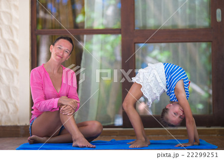 Young woman and little girl engaged in fitness Young woman and little girl engaged in fitness 22299251