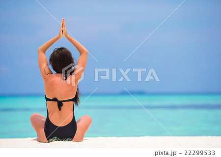Young woman sitting in yoga position during 22299533