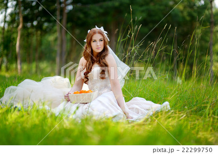 Young bride sitting on a grass 22299750