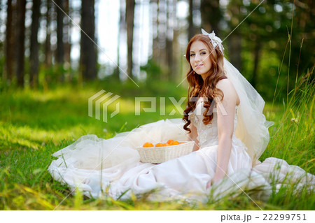Young bride sitting on a grass 22299751