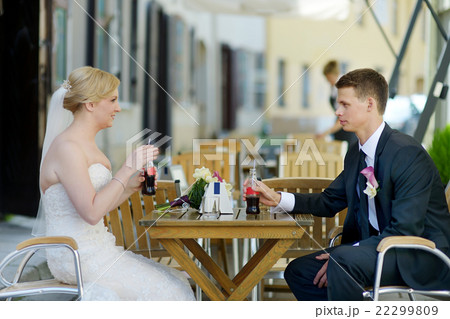 Bride and groom having a refreshing drink 22299809