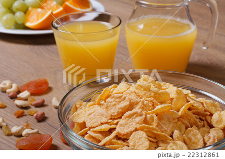 Cornflakes with fruits, nuts and orange juice 22312861