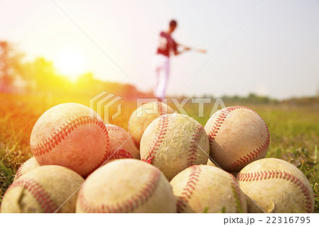 Baseball players practice wave a bat in a field 22316795