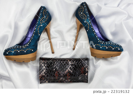 Denim shoes and purse lying on white satin 22319132