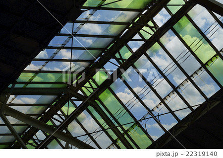 Green glass roof detail of train station over sky 22319140