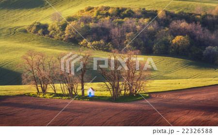 Spring landscape with chapel green fields. Sunset Spring landscape with chapel green fields. Sunset 22326588