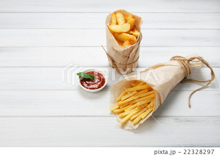 Fries and potato wedges wrapped takeaway at wood 22328297