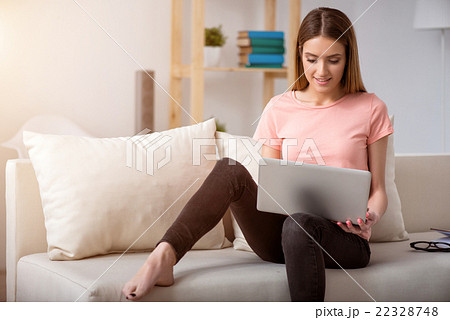 Pleasant woman resting on the couch Pleasant woman resting on the couch 22328748