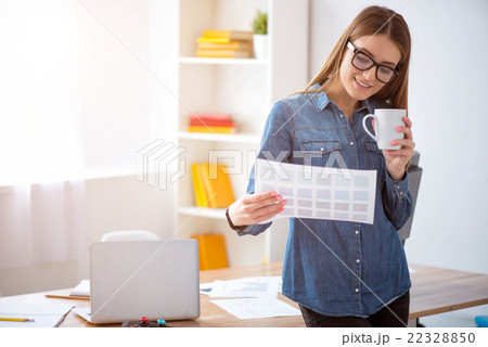 Pleasant delighted woman drinking coffee     22328850