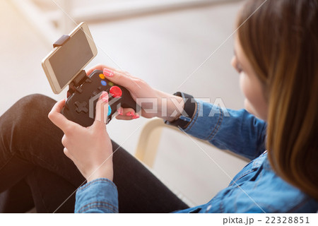 Nice smiling woman using game console     22328851