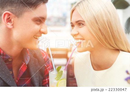 Cheerful boyfriend and girlfriend enjoying sweet Cheerful boyfriend and girlfriend enjoying sweet 22330047