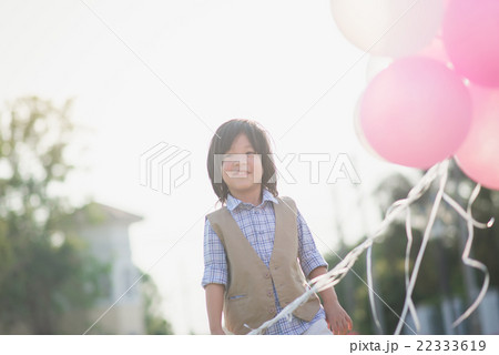 Asian child with many balloons playing in the park Asian child with many balloons playing in the park 22333619