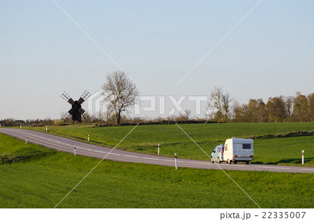 Car with caravan in a green landscape Car with caravan in a green landscape 22335007