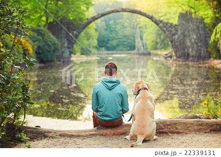 Pensive man sitting with his dog Pensive man sitting with his dog 22339131