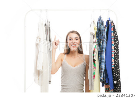 Cheerful woman with finger up standing under Cheerful woman with finger up standing under 22341207