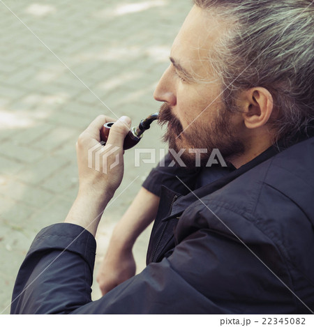 Bearded man smoking pipe, old style 22345082