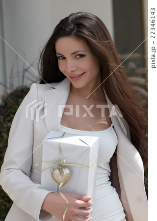 The beautiful young girl with a gift The beautiful young girl with a gift 22346143