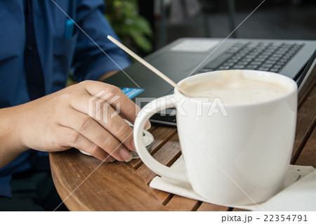 man with a cup of coffee working on his laptop 22354791