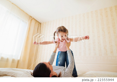 Mother having fun with her daughter in her bedroom Mother having fun with her daughter in her bedroom 22355944