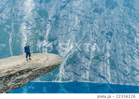 Young Man Standing On Rock In The Mountains Of 22356226