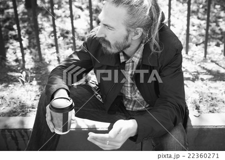 Bearded Asian man with coffee in paper cup Bearded Asian man with coffee in paper cup 22360271
