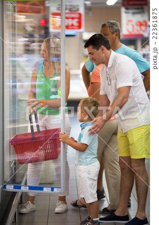 Family choosing food in supermarket Family choosing food in supermarket 22361875