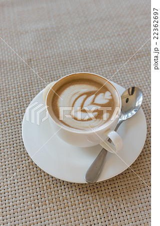 white cup of latte coffee on wooden tray 22362697